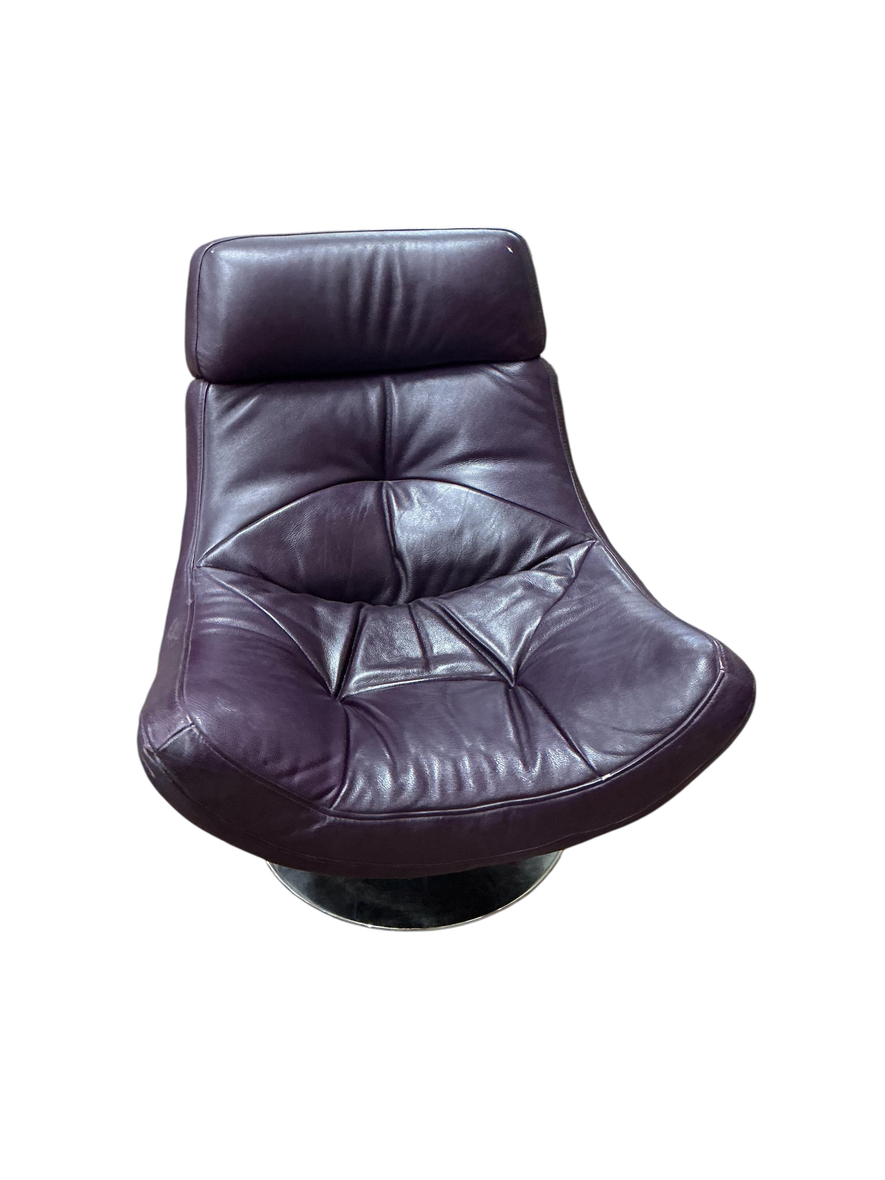 A Contemporary revolving recliner chair, upholstered in purple leather, width 82cm, depth 86cm, height 96cm